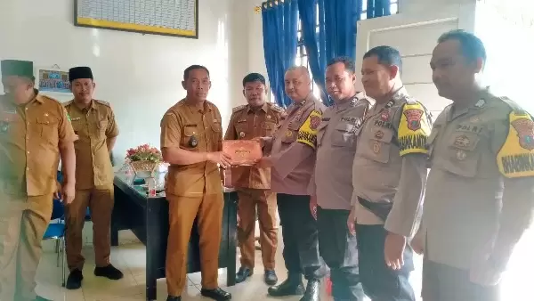Camat Kualuh Hulu didampingi oleh para Kades memberikan cendramata kepada Bhabinkamtibmas