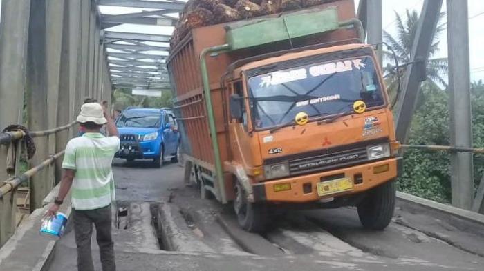 Truk terprosok saat melintasi jembatan Titi Besi yang terletak di desa Kuala Bali kecamatan Serba Jadi, Sergai