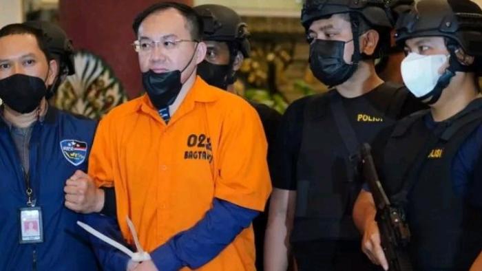 Apin BK saat diborgol dalam pengawasan polisi 